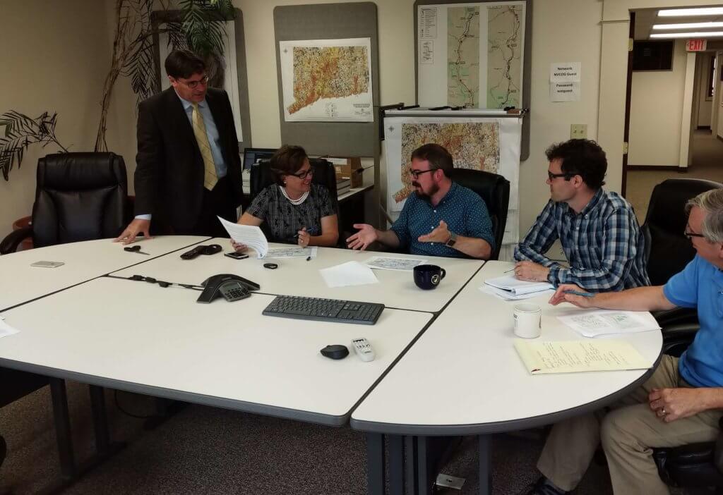 Picture of planners around a table reviewing documents