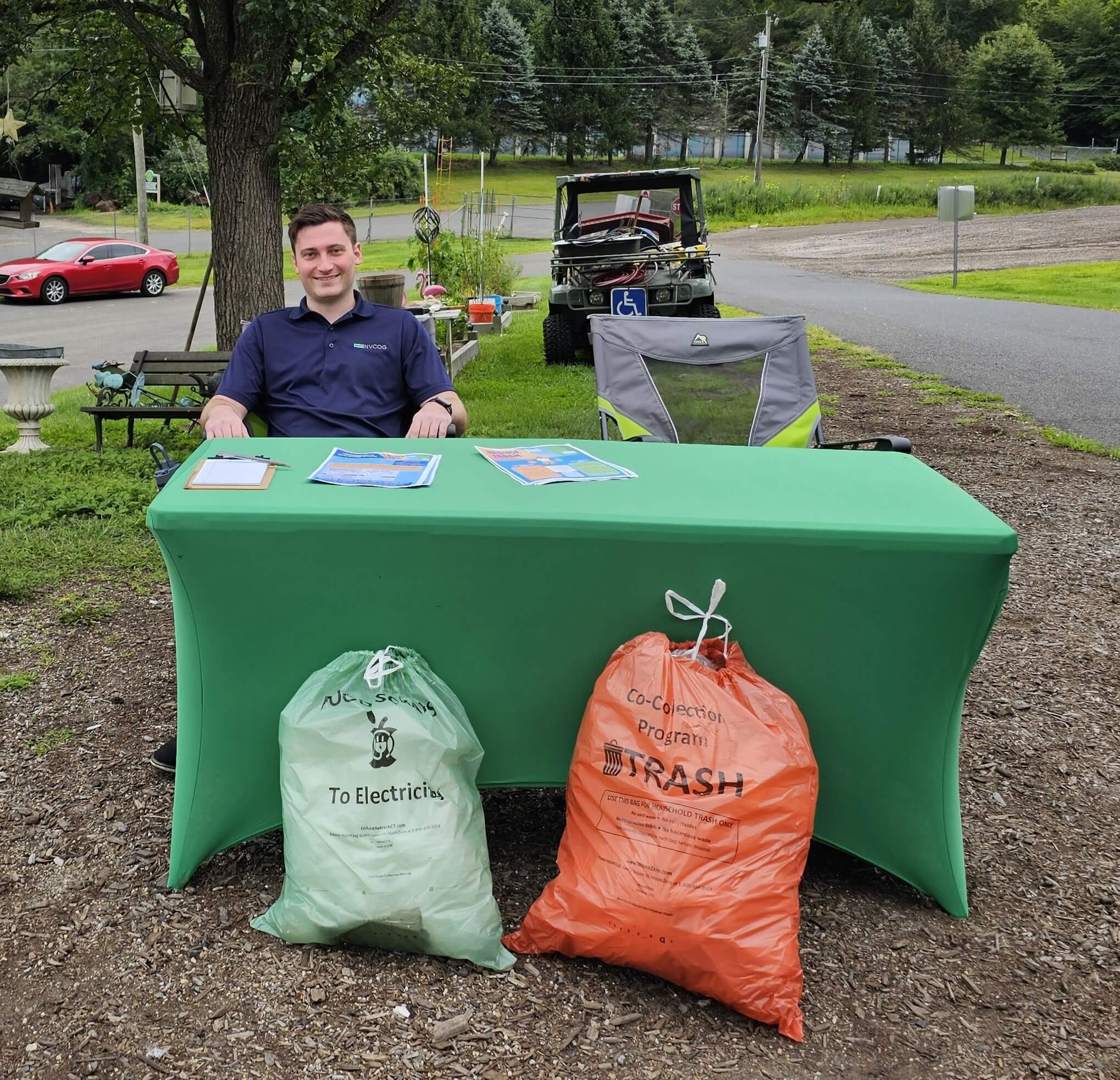 Tom Dougherty, Environmental Planner with NVCOG, tables at the Woodbury Transfer Station to raise awareness about the pilot program.